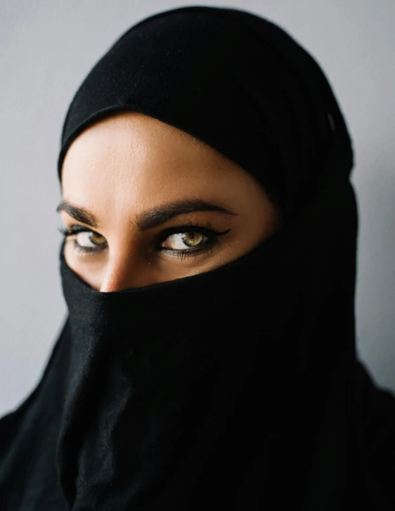 a woman wearing a black hijab, inspired by Hedi Xandt, trending on unsplash, looking straight into camera, queer woman, burka, white woman