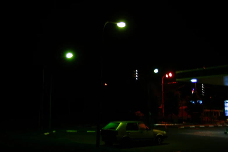 a car parked in front of a gas station at night, inspired by Jan Rustem, under street lamp, green light, dusty volumetric lighting, volumetric lighting - h 7 6 8