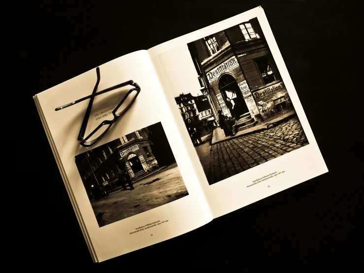 an open book sitting on top of a table, a black and white photo, by Jesper Knudsen, on the streets, eye glass, thumbnail, printed page