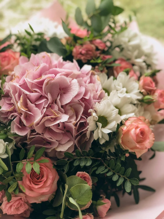 a bouquet of pink and white flowers on a table, upclose, no cropping, hydrangea, intricate detail and quality