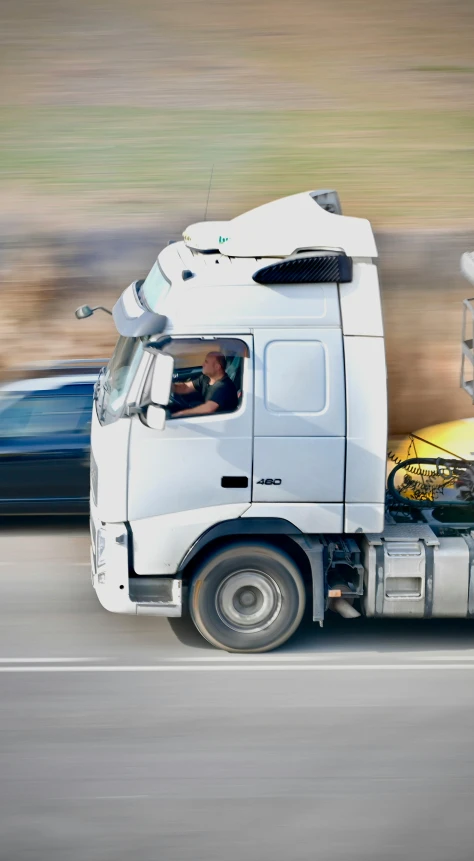 a white truck driving down a road next to a blue car, by Andries Stock, shutterstock, robot made of truck parts, 15081959 21121991 01012000 4k, pictured from the shoulders up, square