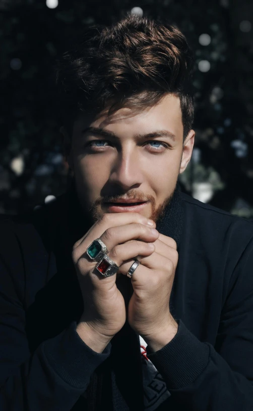 a man with a ring on his finger, an album cover, inspired by Harry Haenigsen, trending on pexels, renaissance, handsome face, gems, official store photo, danila tkachenko