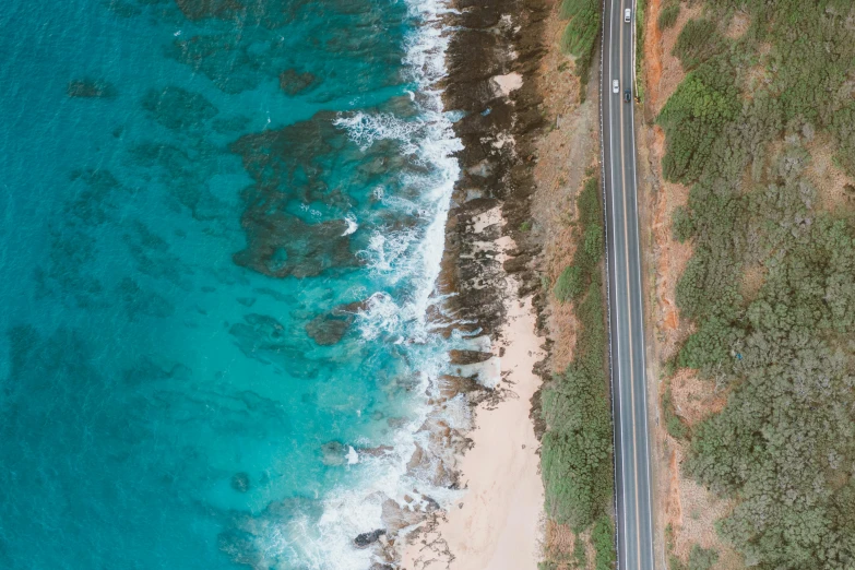 an aerial view of a road next to the ocean, pexels contest winner, cyan and orange, aussie, thumbnail, profile pic