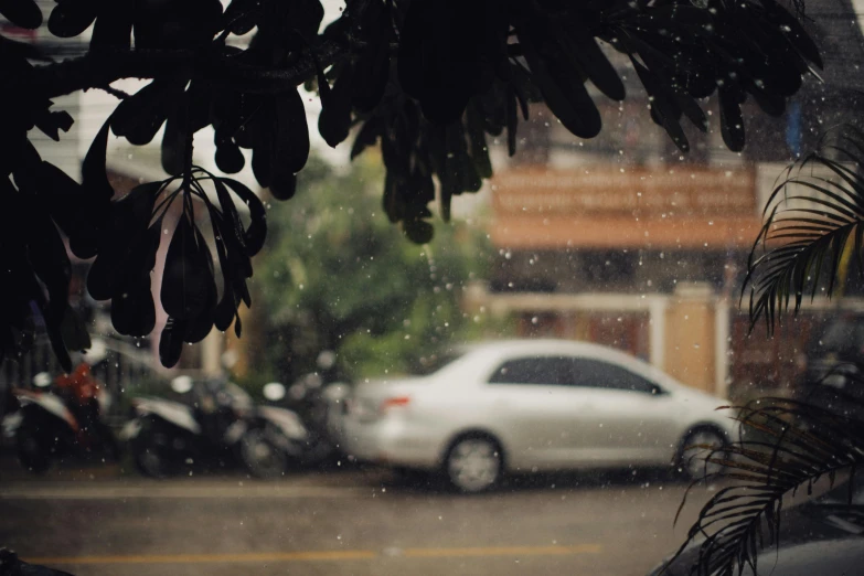 a car is driving down the street in the rain, inspired by Elsa Bleda, pexels contest winner, snowstorm ::5, cars parked, monsoon on tropical island, background image