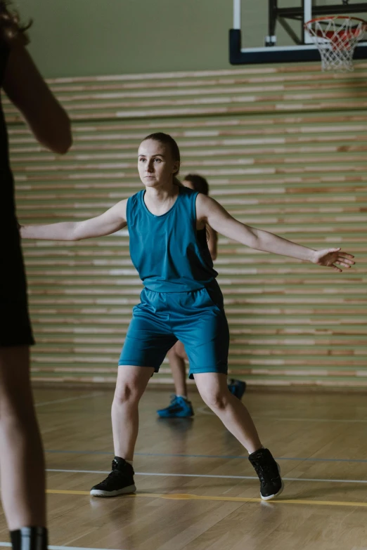 a group of people playing a game of basketball, portrait of sanna marin, power stance, getty images proshot, low quality footage