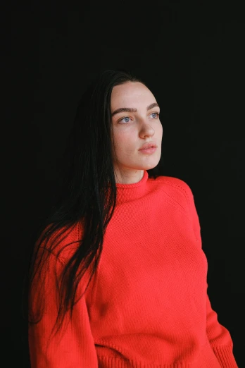 a woman with long black hair wearing a red sweater, an album cover, inspired by Louisa Matthíasdóttir, pexels contest winner, looking straight to camera, an all white human, androgynous person, standing with a black background