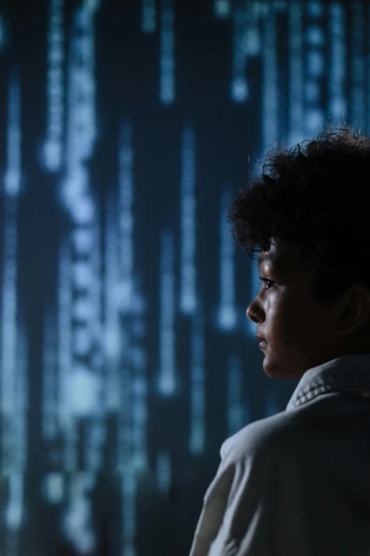 a man standing in front of a computer screen, a hologram, inspired by Ryoji Ikeda, unsplash, ascii art, portrait of willow smith, ignant, boys, standing in a server room