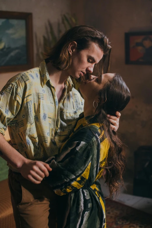 a man standing next to a woman in a living room, a portrait, trending on pexels, renaissance, reylo kissing, wearing yellow floral blouse, hozier, promotional image