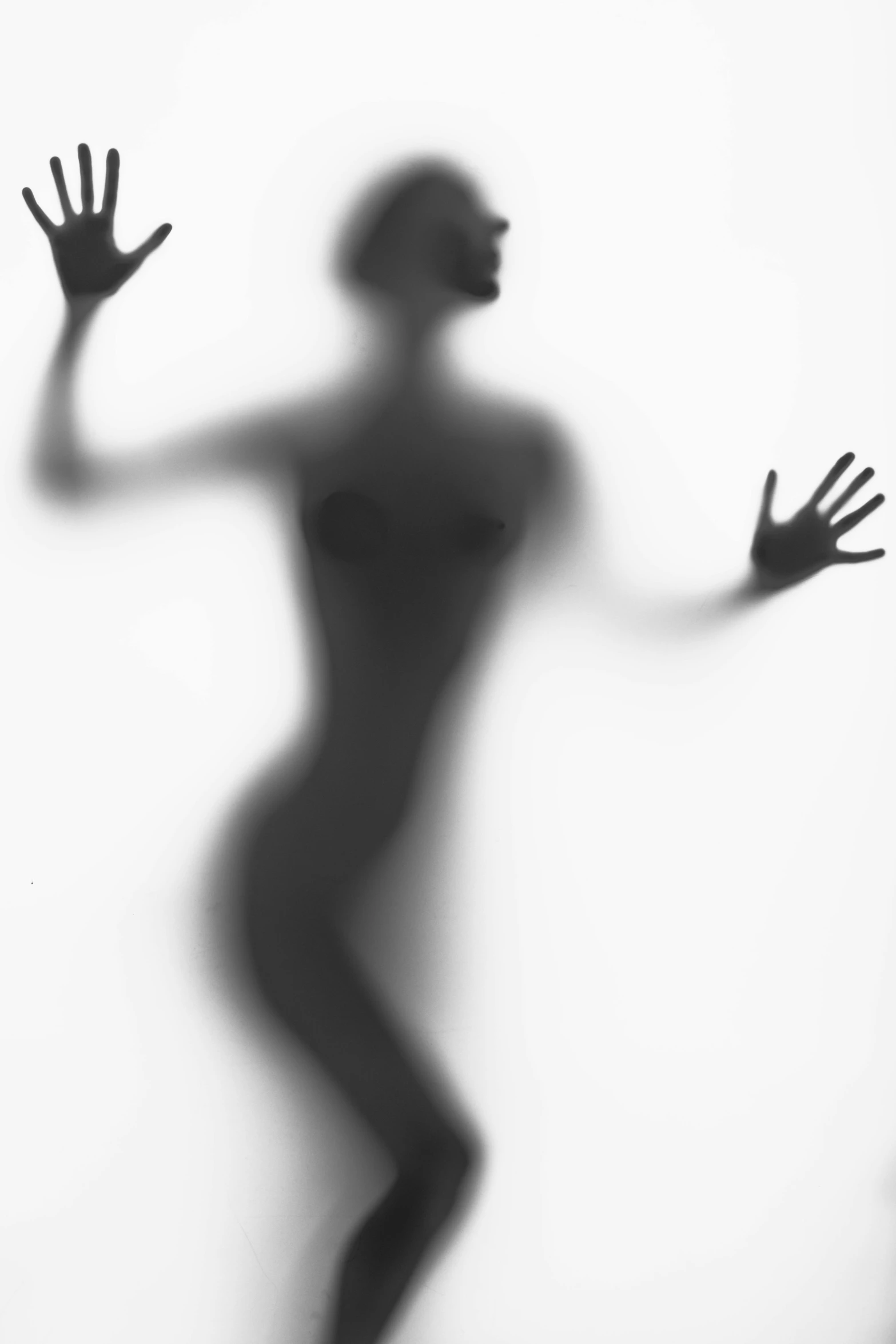 a black and white photo of a person with their hands in the air, inspired by Lillian Bassman, tumblr, conceptual art, ffffound, beautiful female body silhouette, nick knight, alien woman