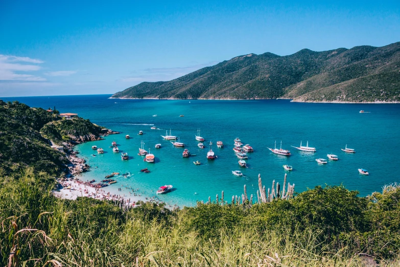 a large body of water filled with lots of boats, a photo, by Felipe Seade, pexels contest winner, turquoise water, brazil, 🚿🗝📝