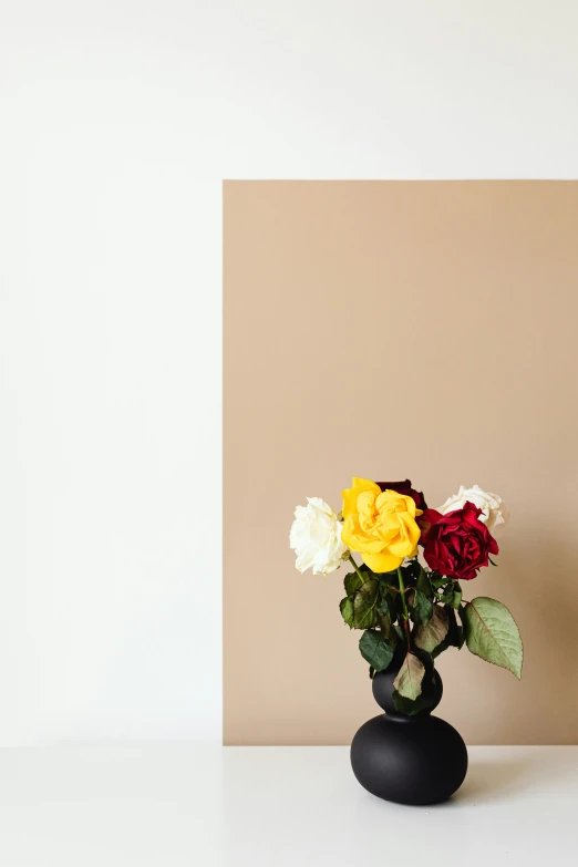 a vase filled with flowers sitting on top of a table, a minimalist painting, inspired by Robert Mapplethorpe, unsplash, a few roses, muted brown yellow and blacks, ignant, three colors