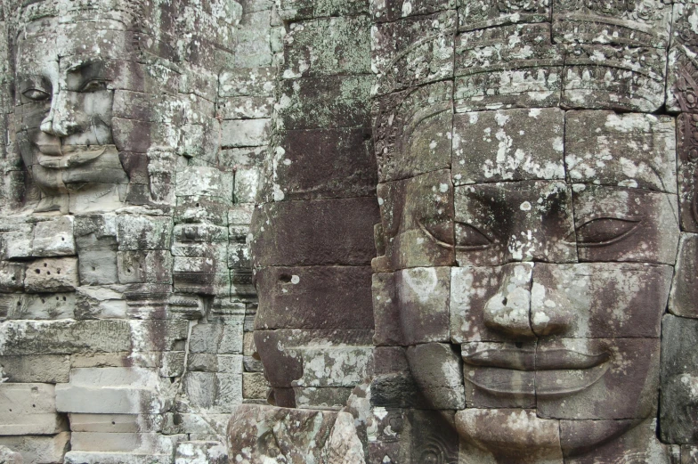 a close up of a face on a stone wall, a statue, large temples, avatar image