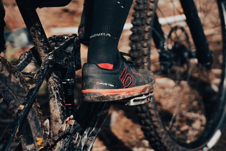 a close up of a person riding a bike, covered in dirt, socks, high quality product image”, avatar image