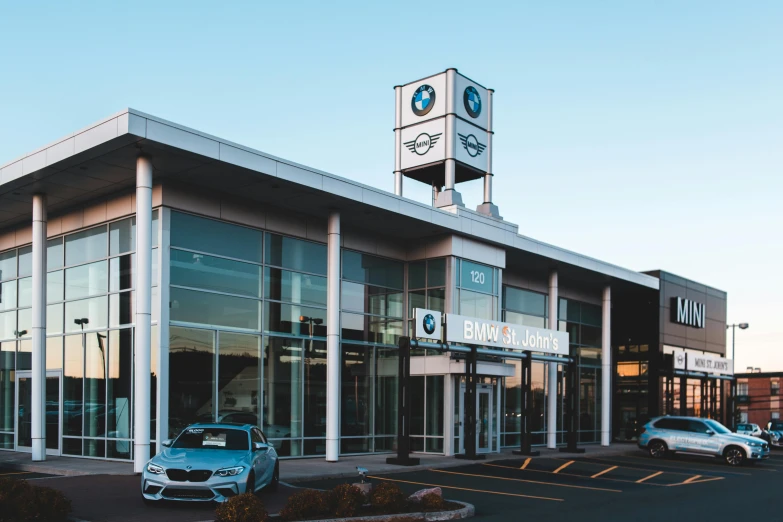 a bmw dealership with cars parked in front of it, by Josh Bayer, unsplash contest winner, bauhaus, quebec, square, ad image