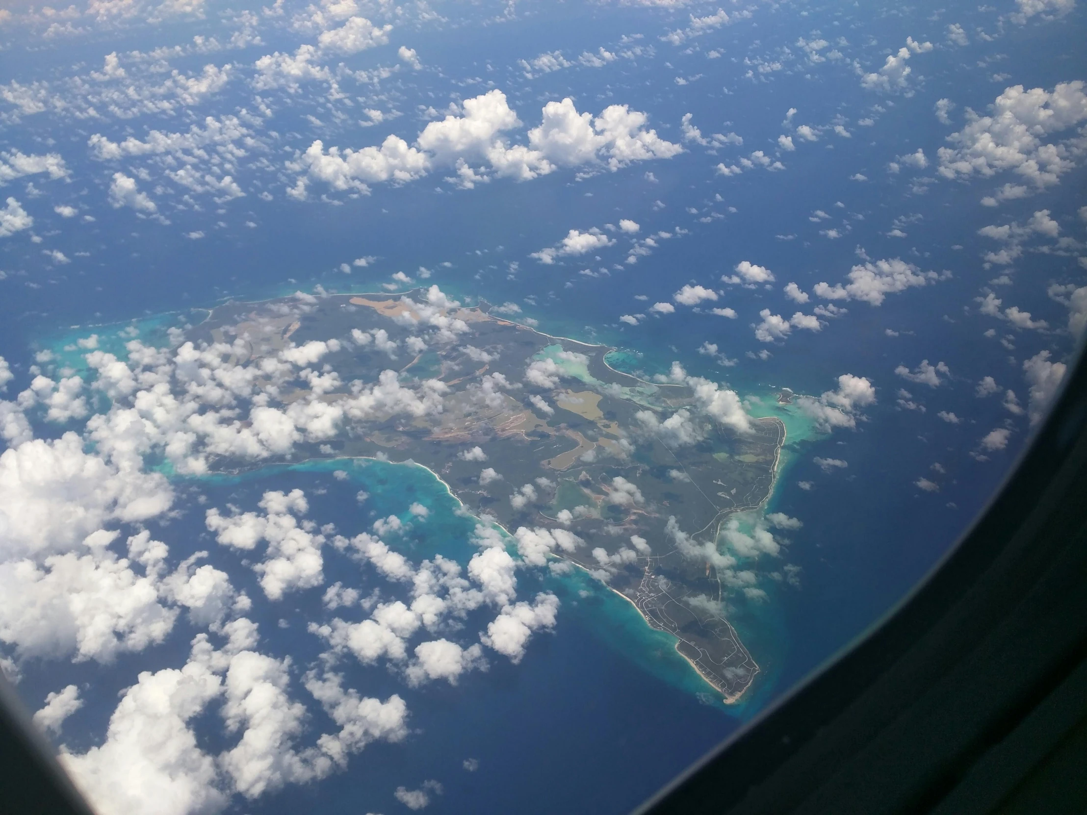 a view of the ocean from an airplane window, a photo, on an island, thumbnail, ground level shot, posing