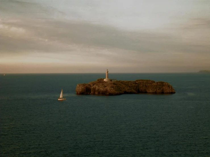 a lighthouse on a small island in the middle of the ocean, by Alasdair Grant Taylor, pexels contest winner, minimalism, still from the movie ex machina, sailing boat, costa blanca, olafur eliasson