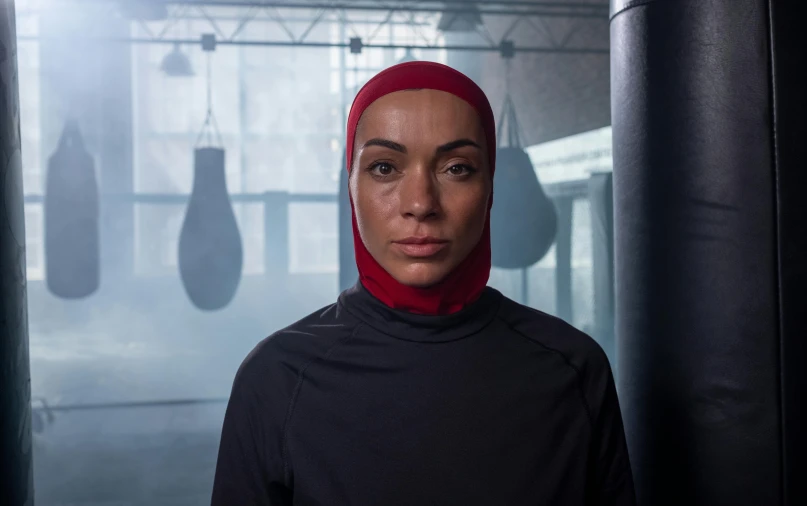 a woman wearing a hijab stands in a boxing ring, hyperrealism, actor, digital still, charli bowater, **cinematic