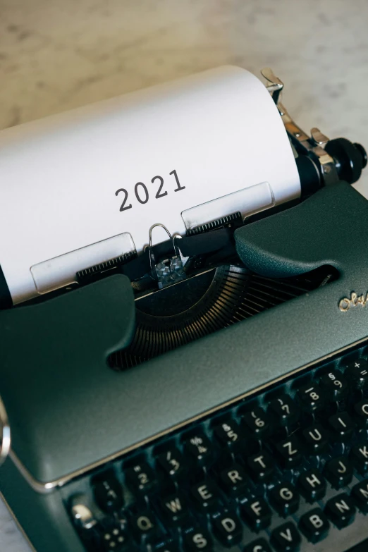 a typewriter sitting on top of a wooden table, by Carey Morris, trending on pexels, happening, new years eve, from star trek 2021, thumbnail, bl