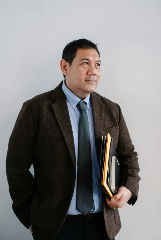 a man in a suit and tie holding a book, josan gonzales, wearing jacket, akiman, profile image