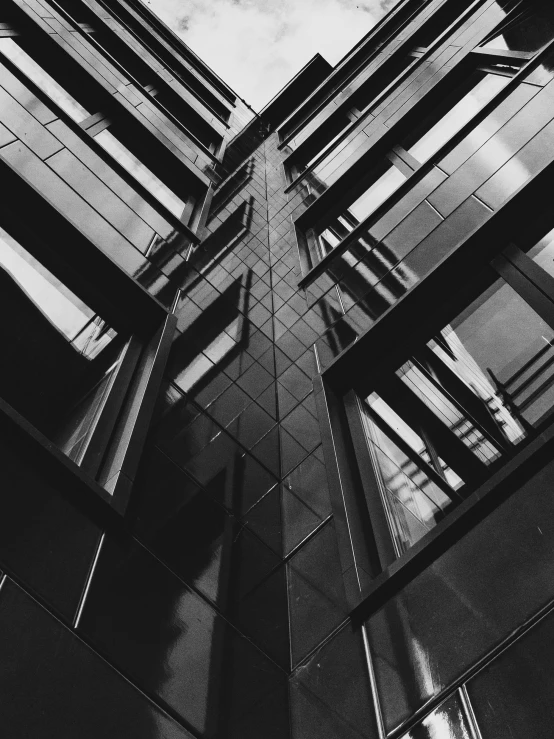 a black and white photo of a tall building, by andrei riabovitchev, unsplash, full of glass. cgsociety, shot with iphone 1 0, square lines, detailed medium format photo