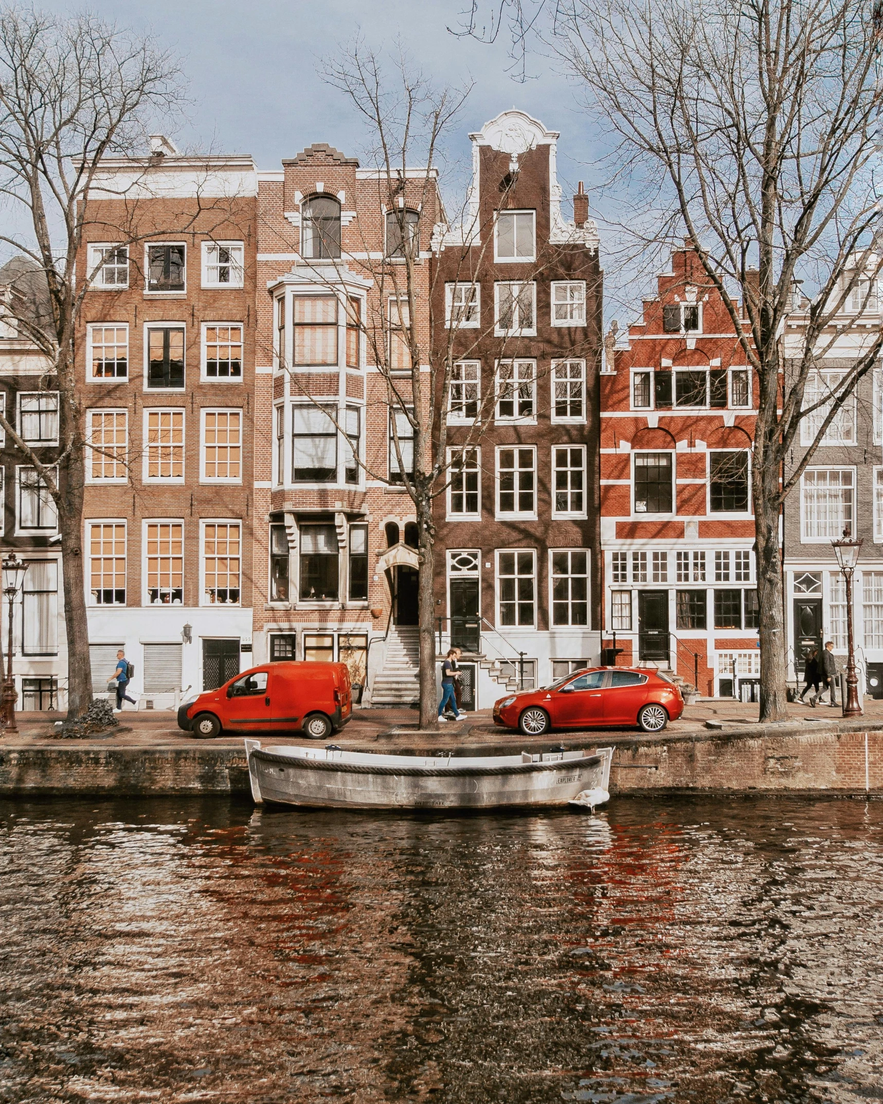 a boat sitting on top of a river next to tall buildings, by Jan Tengnagel, pexels contest winner, de stijl, small cottage with red shutters, 🚿🗝📝, thumbnail, canals