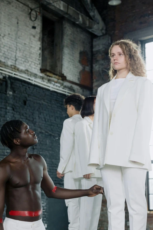 a group of people standing next to each other, inspired by Vanessa Beecroft, renaissance, white suit, adut akech, a boy, ny