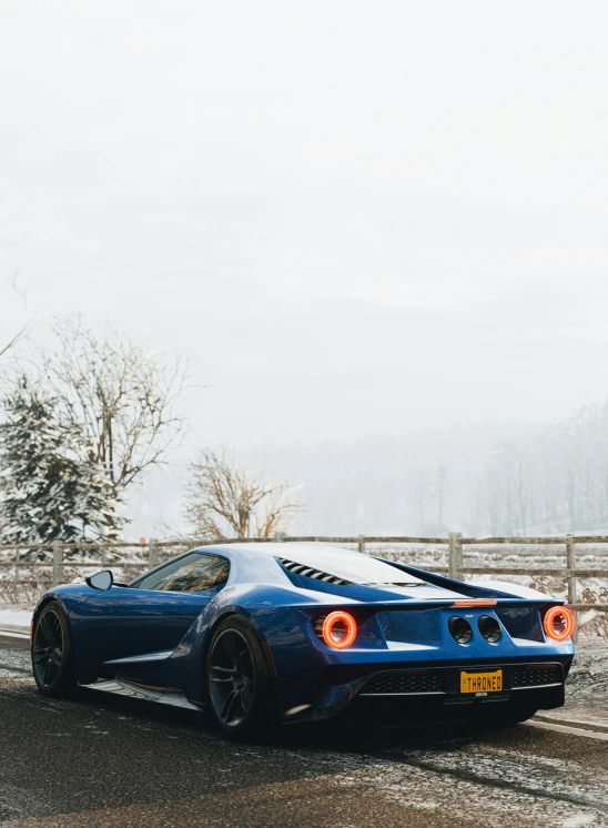 a blue sports car driving down a snowy road, inspired by Harry Haenigsen, pexels contest winner, full body shot 4k, gt40, 🚿🗝📝, modern minimalist f 2 0 clean