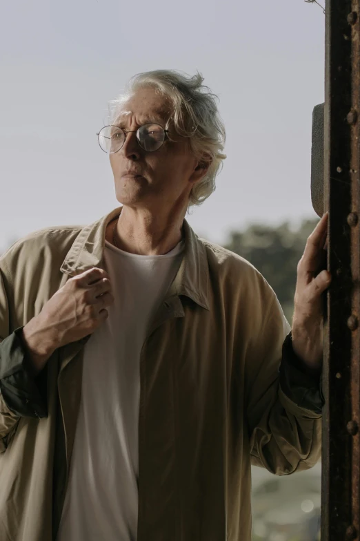 a man that is standing in front of a door, inspired by roger deakins, unsplash, photorealism, wearing silver hair, holding a wood piece, man looks out of a train window, ( ( theatrical ) )