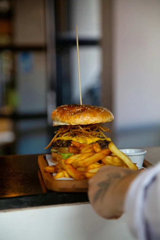 a close up of a person holding a plate of food, burger, daily specials, profile pic, brown