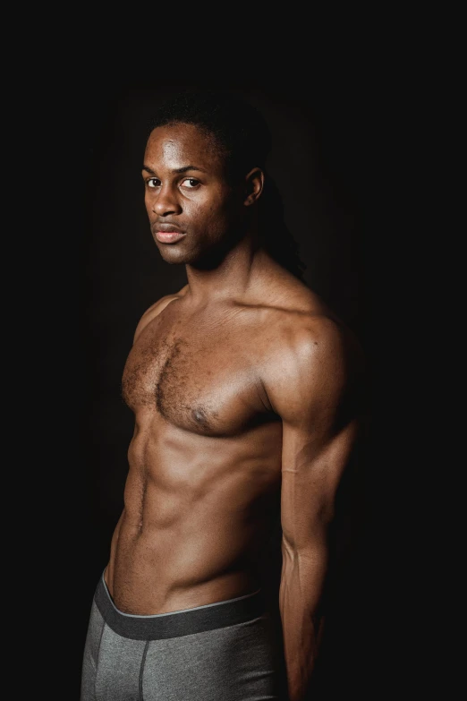 a shirtless man standing in front of a black background, inspired by Leonard Daniels, riyahd cassiem, profile image, promo image