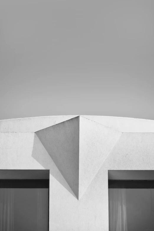 a black and white photo of a building, inspired by Paul Lucien Dessau, unsplash, brutalism, alvaro siza, triangular face, clemens ascher, square