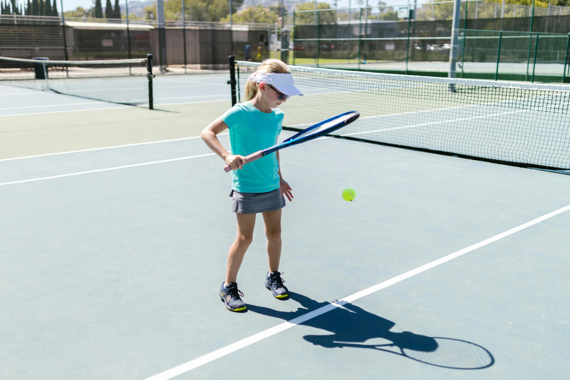 a woman standing on a tennis court holding a racquet, a girl playing tennis, square, shot with sony alpha, medium-shot