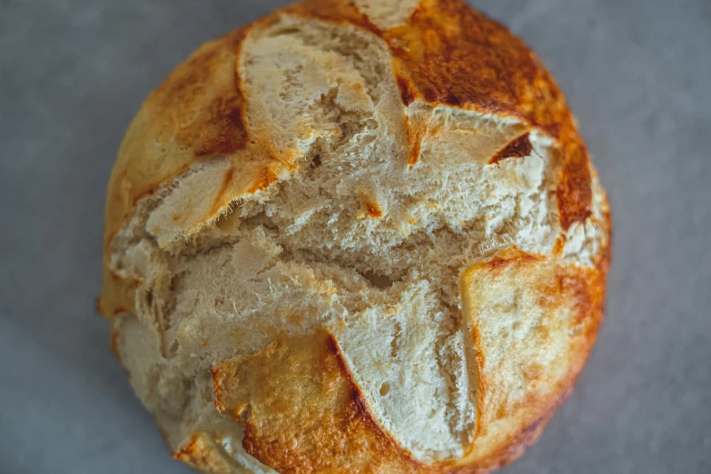 a close up of a loaf of bread on a table, a portrait, unsplash, spherical, top down shot, round-cropped, recipe