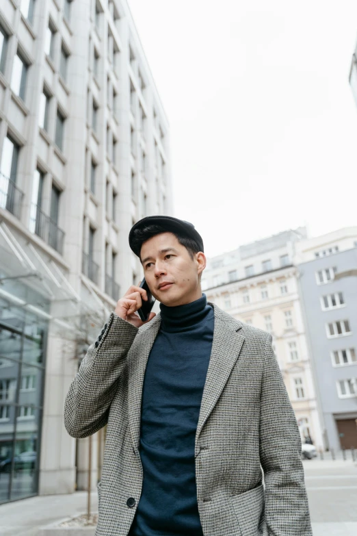 a man walking down a street talking on a cell phone, trending on pexels, realism, asian male, berlin fashion, 🚿🗝📝, androgynous person