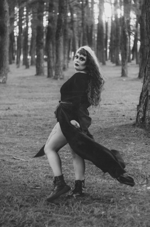 a black and white photo of a woman in a forest, tumblr, full body with costume, as a vampire, profile photo, witchy clothing