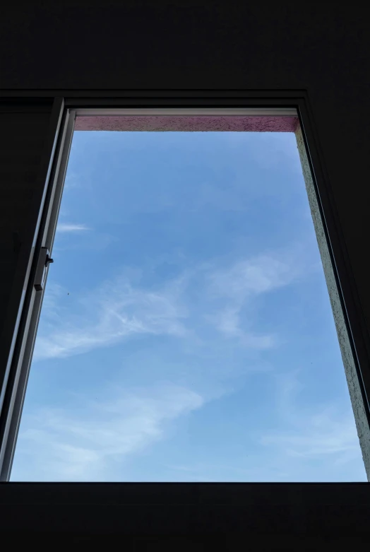 a view of a blue sky through a window, by Rachel Reckitt, light and space, about to enter doorframe, the sky is pink, in the morning, photograph taken in 2 0 2 0