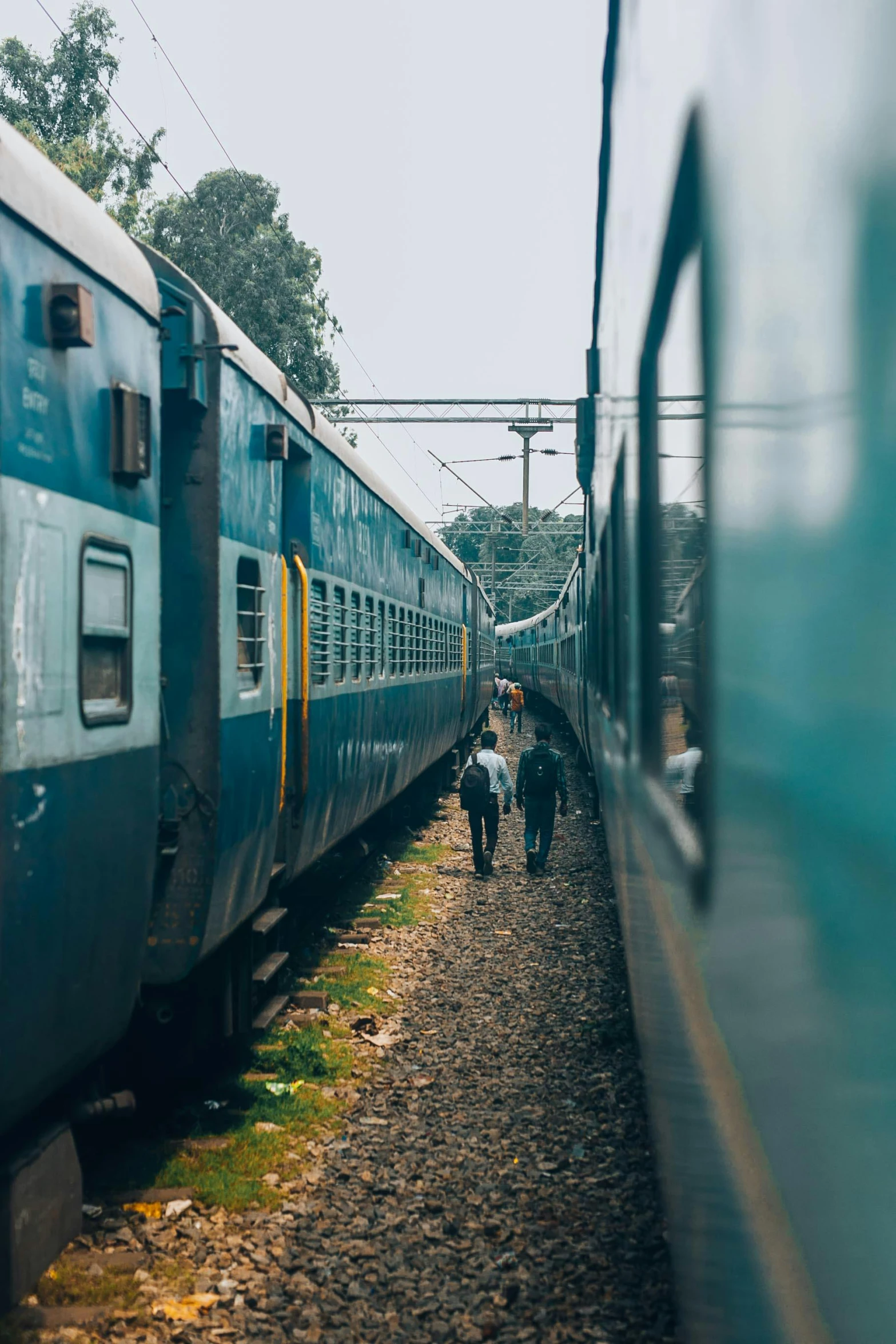 a couple of trains that are next to each other, inspired by Steve McCurry, pexels contest winner, happening, india, 🚿🗝📝, cute boys, square