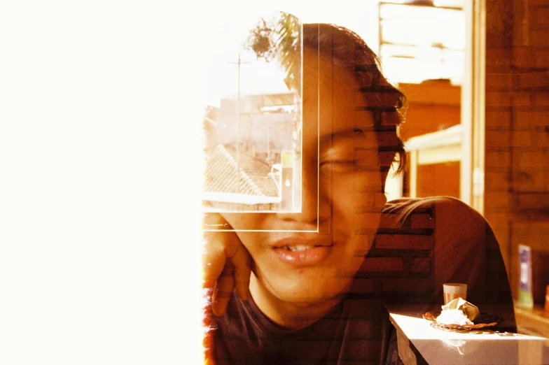 a man sitting at a table with a slice of cake in front of him, a picture, by Jan Rustem, unsplash, young glitched woman, looking through a window frame, asian face, taken in the late 2000s