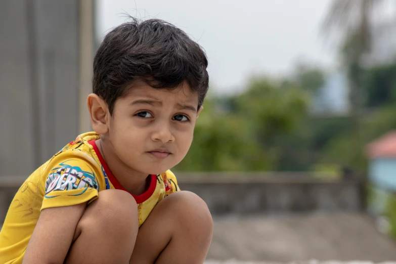 a young boy sitting on top of a skateboard, pexels contest winner, hyperrealism, indian girl with brown skin, concerned expression, cute boys, high resolution photo