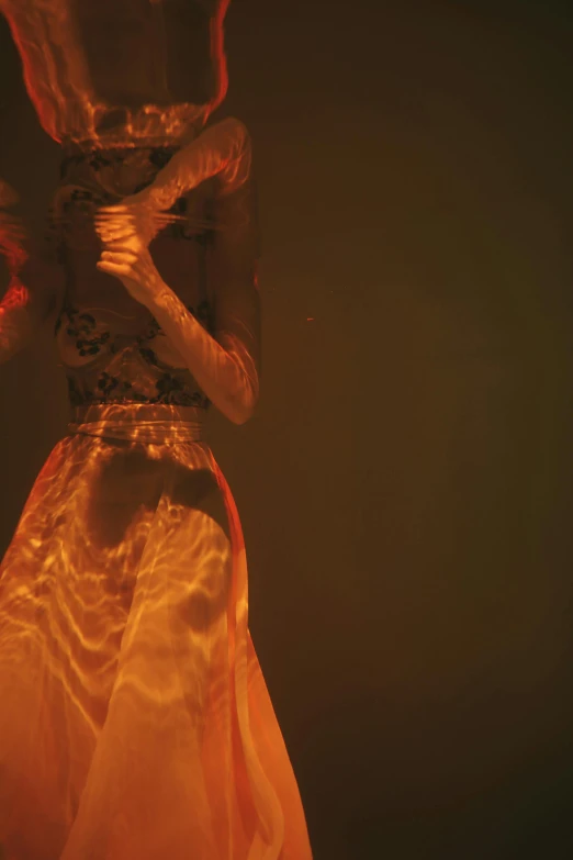 a close up of a statue of a woman in a dress, an album cover, inspired by Elsa Bleda, renaissance, mangeta smoke red light, concert footage, orange yellow ethereal, full body in shot