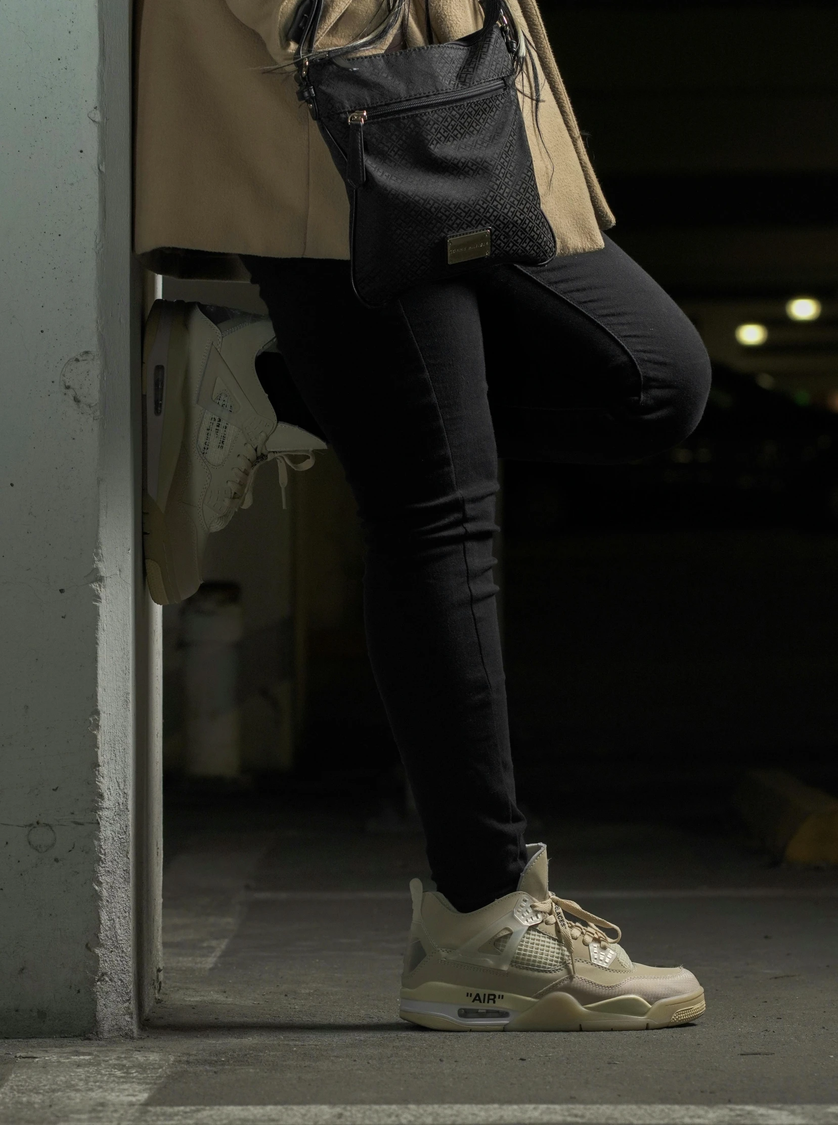 a woman leaning against a wall talking on a cell phone, by Android Jones, unsplash, realism, sneaker photo, dark and beige atmosphere, style of kentaro miura!!!!, ( ( ( wearing jeans ) ) )