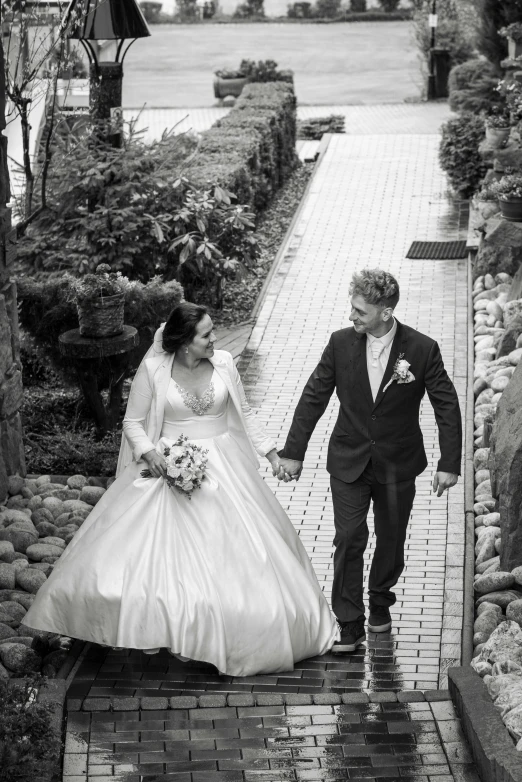 a black and white photo of a bride and groom, a black and white photo, by Chris Rallis, pixabay contest winner, walking at the garden, smiling down from above, lachlan bailey, - photorealistic