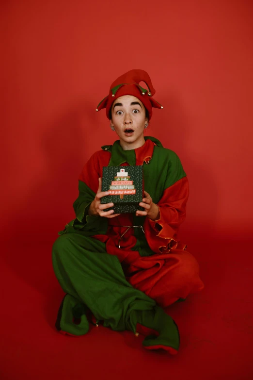 a man dressed as an elf holding a cake, an album cover, inspired by Ernest William Christmas, pexels contest winner, 2 5 6 x 2 5 6 pixels, robert sheehan, gemma chen, 15081959 21121991 01012000 4k