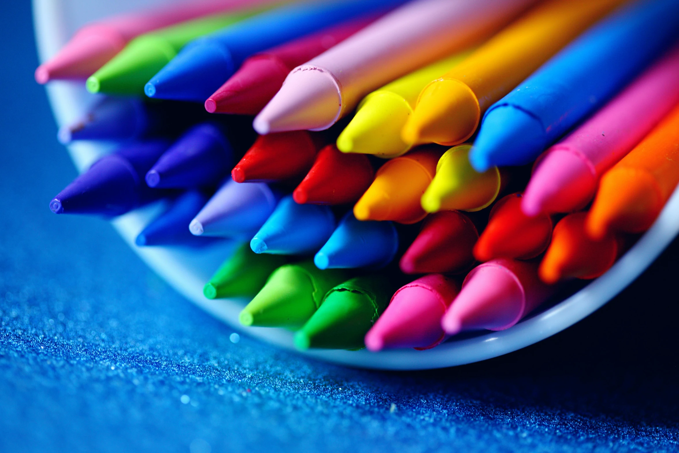 a close up of a bowl of colored crayons, by Julia Pishtar, professional color photography, pastelle colors, rainbow coloured rockets, ilustration