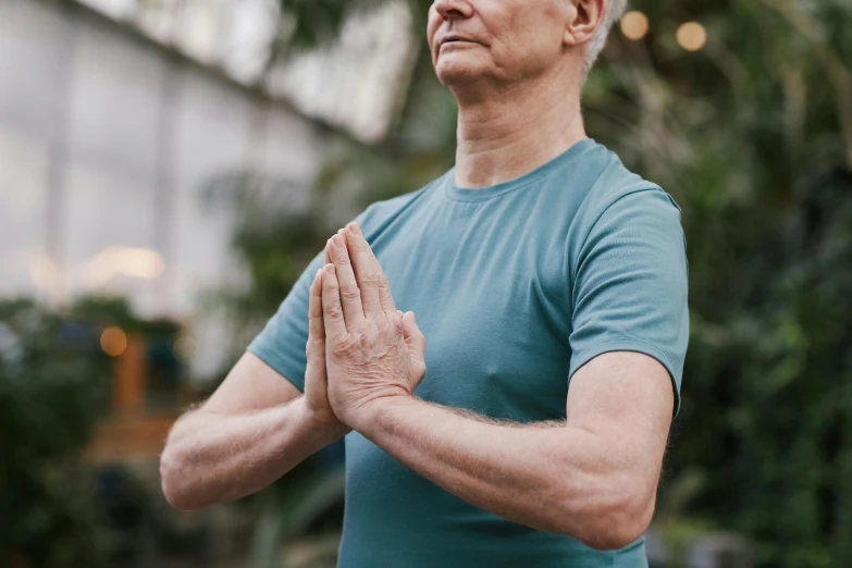 a man in a blue shirt doing a yoga pose, pexels contest winner, renaissance, aging, on his right hand, upper body image, acupuncture treatment