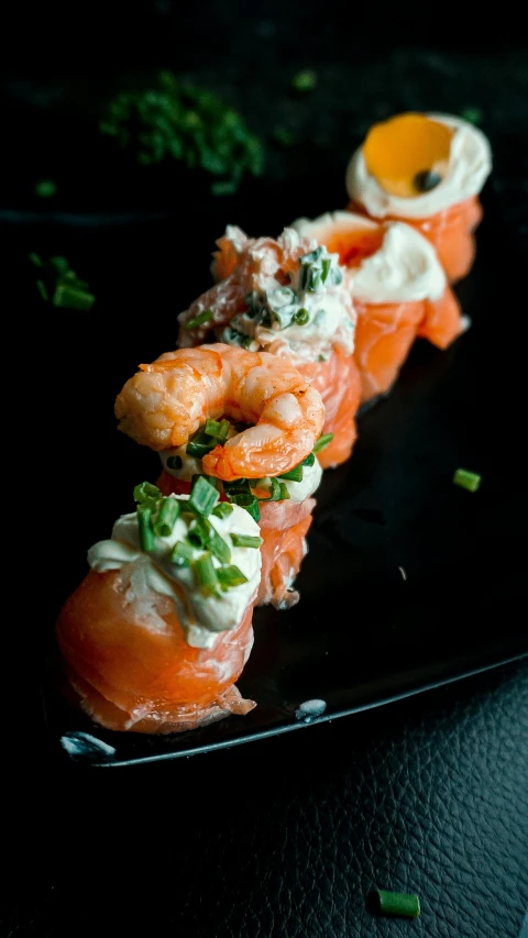 a close up of a plate of food on a table, crustacean, with a black background, salmon, thumbnail