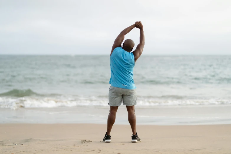 a man standing on top of a sandy beach, pixeled stretching, profile image, overweight, earl