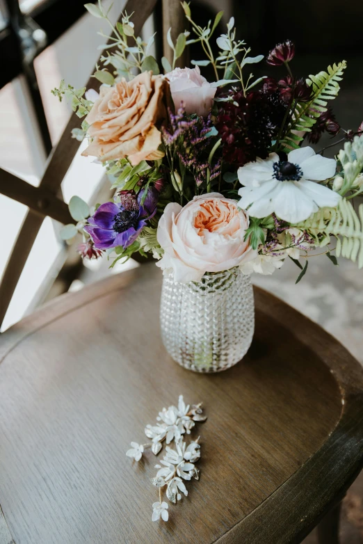 a vase filled with flowers sitting on top of a wooden chair, by Robbie Trevino, sparkling crystals, cute details, glassware, smooth details