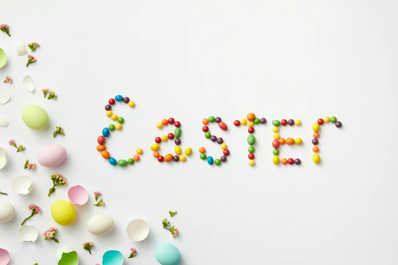 a white table topped with lots of colorful candies, by Ellen Gallagher, trending on unsplash, graffiti, easter, lettering clean, made of food, egg