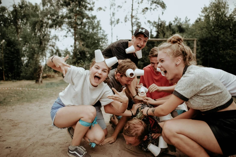 a group of people sitting on top of a dirt field, funny faces, summer camp, avatar image, stacked image